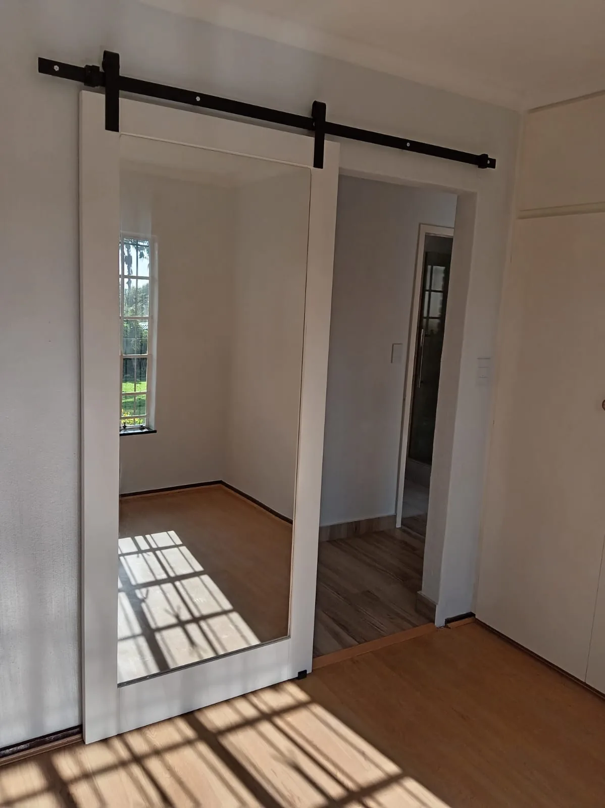 Full-length mirror sliding door, custom commission by Eminent Door & More
